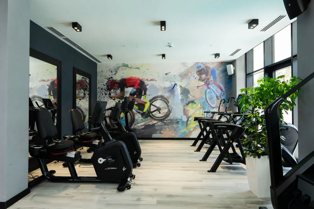 Exercise bikes by the mural wall